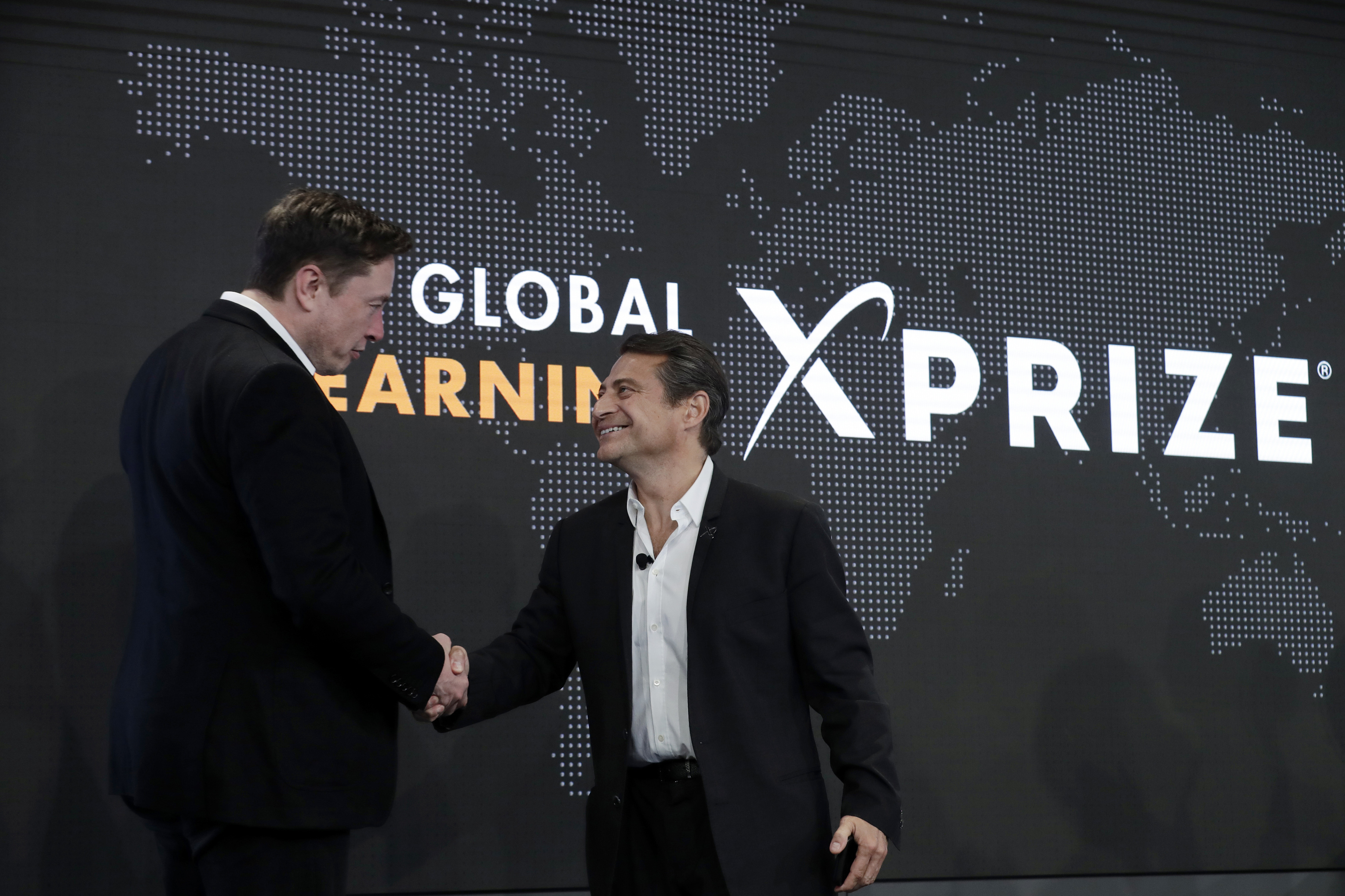 Elon Musk shakes hands with Peter Diamandis in 2019. Elon Musk shakes hands with Peter Diamandis in 2019.