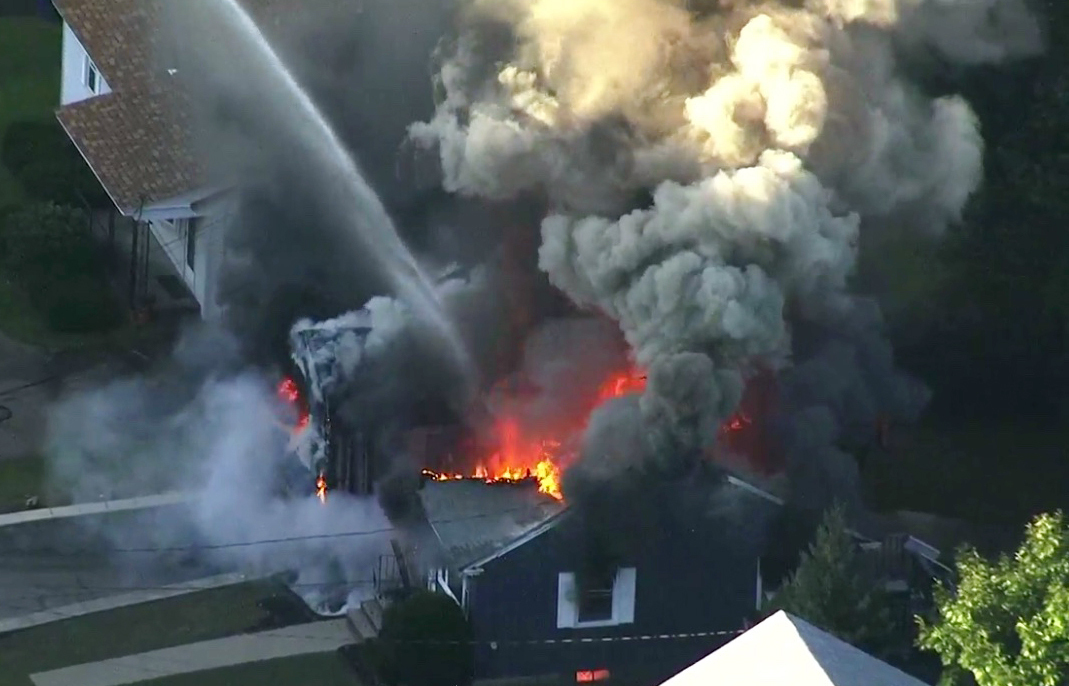 Flames consume the roof of a home in Lawrence, Massachusetts, after a gas explosion in 2018. Flames consume the roof of a home in Lawrence, Massachusetts, after a gas explosion in 2018.